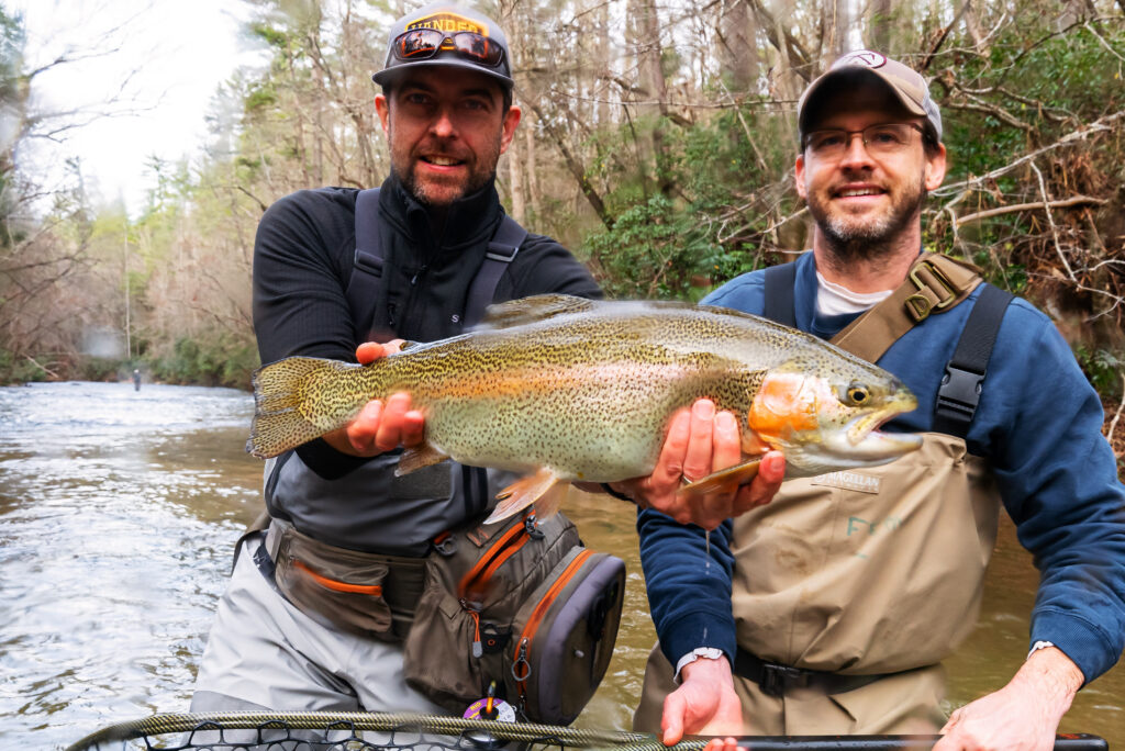large fish caught by two people fishing