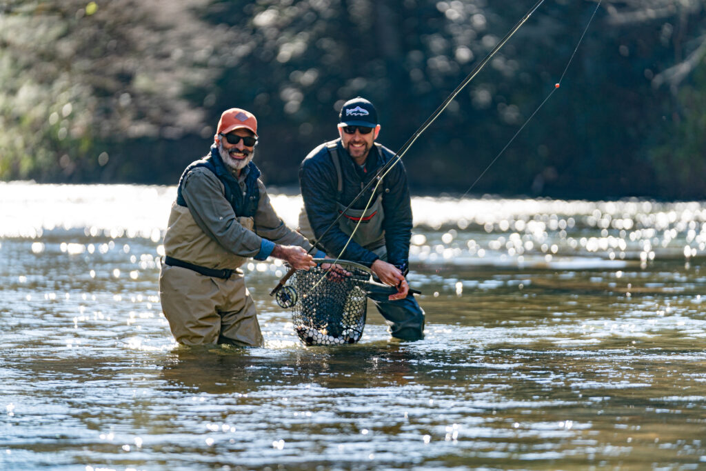 two guides wading in the river