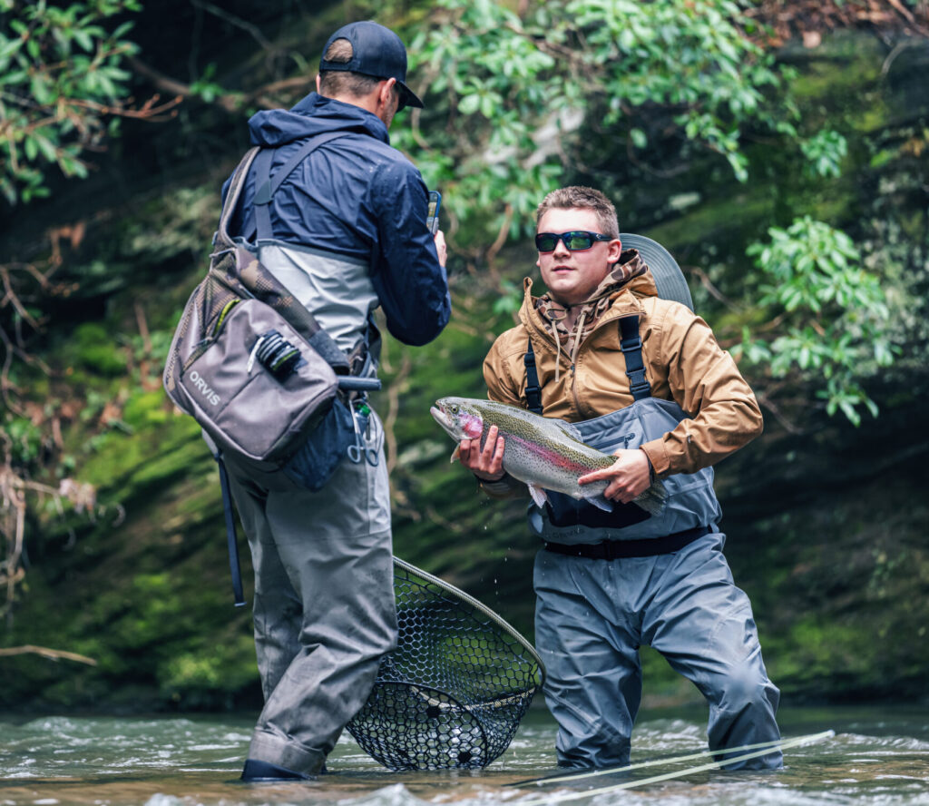 kid posing for a picture with a fish